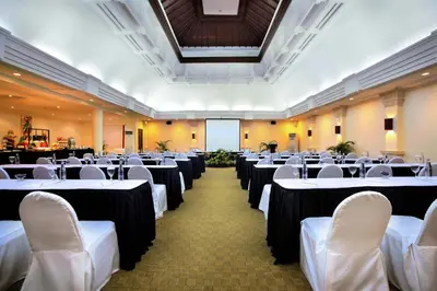 a banquet hall with white tables and white chairs at Hotel Nikko Bali Benoa Beach in Nusa Dua