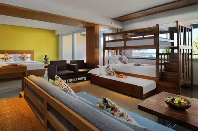a living room with two beds and a loft bed at Hotel Nikko Bali Benoa Beach in Nusa Dua
