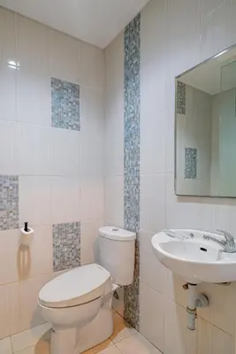 a bathroom with a toilet and a sink at Dream @ Jimbaran in Jimbaran