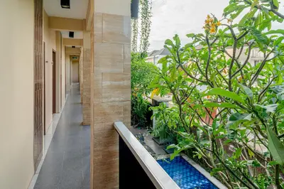 a corridor of a building with a garden at Dream @ Jimbaran in Jimbaran