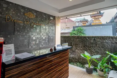 a restaurant with a counter and plants in a room at Dream @ Jimbaran in Jimbaran