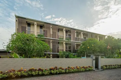 an apartment building with a fence in front of it at Dream @ Jimbaran in Jimbaran