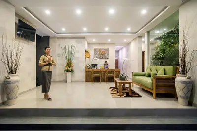 a man is standing in a lobby at Sandi Agung Villa Bidadari in Seminyak
