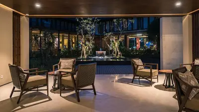 a group of chairs and a table in a building at Ramayana Suites and Resort in Kuta