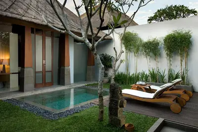 a villa with a swimming pool and a resort at The Kayana in Seminyak
