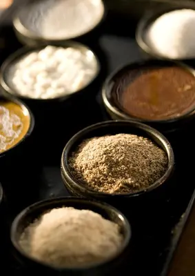 a group of containers filled with different types of ingredients at The Kayana in Seminyak