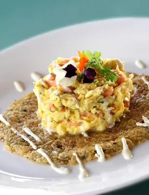 a piece of food on a white plate on a table at The Samaya Seminyak Bali in Seminyak