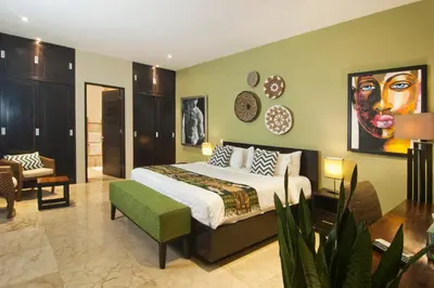 a bedroom with a king sized bed in a room at Villa Uma Sari - 2BDR, Private Pool and Sunset Rooftop, Quiet and Central in Seminyak