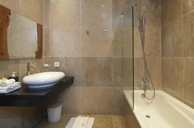 a bathroom with a shower and a sink and a tub at Villa Uma Sari - 2BDR, Private Pool and Sunset Rooftop, Quiet and Central in Seminyak