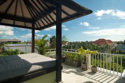 a bedroom with a bed on a balcony at Villa Uma Sari - 2BDR, Private Pool and Sunset Rooftop, Quiet and Central in Seminyak