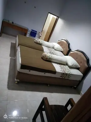 a man laying on a couch in a room at Rumah Retret Bethania in Kuta