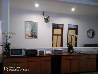 a room with a counter with two mirrors at Rumah Retret Bethania in Kuta
