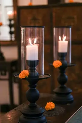 two candles in glass vases on a table at Mosan House - unique art-filled gem in perfect location a short walk from the beach or Seminyak Square including AC office for remote working in Seminyak