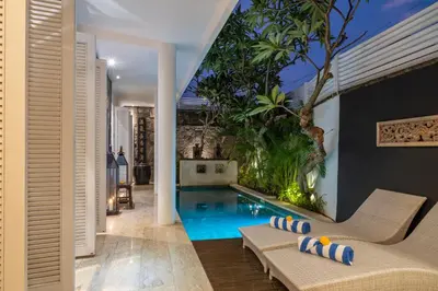 an indoor swimming pool in the middle of a house at Mosan House - unique art-filled gem in perfect location a short walk from the beach or Seminyak Square including AC office for remote working in Seminyak