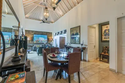 a dining room with a table and chairs at Mosan House - unique art-filled gem in perfect location a short walk from the beach or Seminyak Square including AC office for remote working in Seminyak