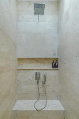 a bathroom with a shower with a basketball hoop at Mosan House - unique art-filled gem in perfect location a short walk from the beach or Seminyak Square including AC office for remote working in Seminyak