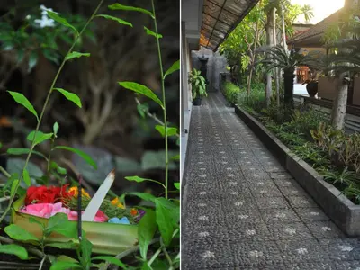 a walkway in front of a house with flowers at Jesens Inn II in Kuta
