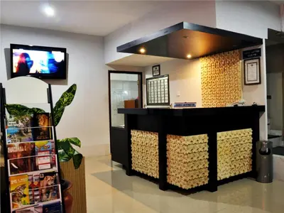 a cashier counter in a store with a tv at Jesens Inn II in Kuta