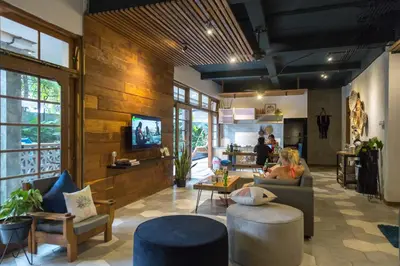 a living room with a person sitting on a couch at Interconnection Hostel in Kuta