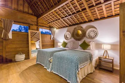 a bedroom with a bed and a large window at Villa HOI by Alfred in Bali in Seminyak