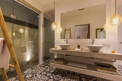 a bathroom with two sinks and a shower at Villa HOI by Alfred in Bali in Seminyak