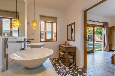 a bathroom with a tub and a sink at Villa HOI by Alfred in Bali in Seminyak