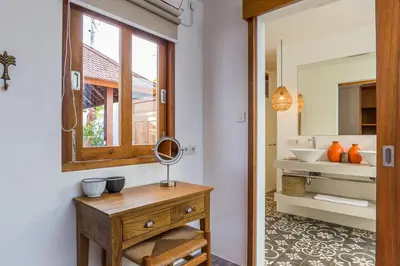 a bathroom with a wooden table and a mirror at Villa HOI by Alfred in Bali in Seminyak