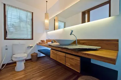 a bathroom with a bowl sink and a toilet at VILLA OLYMPIA in Seminyak