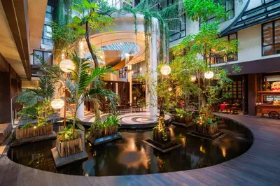 arium of a shopping mall with trees and plants at Swiss-Belhotel Rainforest in Kuta