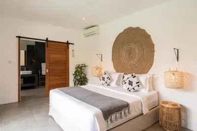 a bedroom with a large white bed and a mirror at House of Bagera by Alfred in Bali in Seminyak