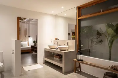 a bathroom with two sinks and a mirror at House of Bagera by Alfred in Bali in Seminyak