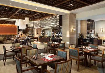 a dining room with tables and chairs in a restaurant at Conrad Bali in Nusa Dua