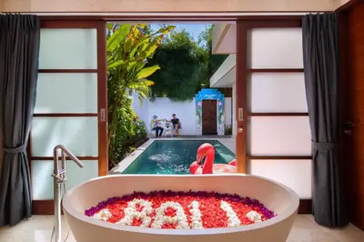 a bath tub with a pool in a room at Beautiful Bali Villas - 6 mins walk to the beach in Legian