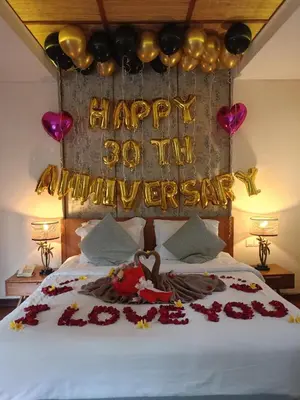 a bed with a happy anniversary sign and roses at Beautiful Bali Villas - 6 mins walk to the beach in Legian