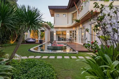 a house with a backyard with a fountain at Luxury - Villa K - Central Seminyak in Seminyak