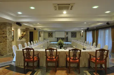 a conference room with a long table and chairs at Hotel Kumala Pantai in Legian