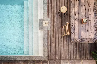 an overhead view of a swimming pool with a wooden deck at Brown Feather Batu Belig in Seminyak