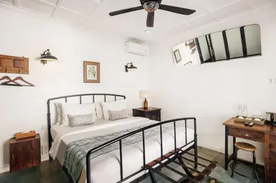 a bedroom with a bed and a ceiling fan at Brown Feather Batu Belig in Seminyak