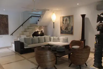 a living room with a couch and a table with chairs at Villa Casa Bali - your home away from home in Seminyak