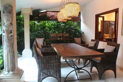 a dining room with a wooden table and chairs at Villa Casa Bali - your home away from home in Seminyak