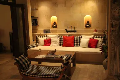 a living room with a couch with red and white pillows at Villa Casa Bali - your home away from home in Seminyak