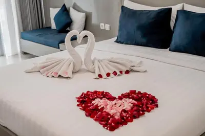 two swans making a heart on a bed at The Rooms Apartment Bali by ARM Hospitality in Denpasar