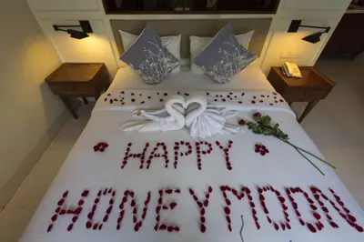 a bed with the words happy anniversary written on it at Seminyak Lagoon All Suites Hotel in Seminyak