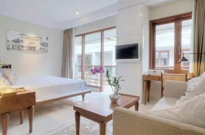 a living room with a bed and a couch at Seminyak Lagoon All Suites Hotel in Seminyak