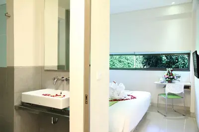 a bathroom with a white tub and a sink at J Hotel Kuta in Kuta
