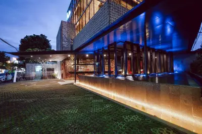 a building with blue lights on the side of it at J Hotel Kuta in Kuta