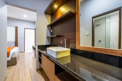 a bathroom with a sink and a mirror at Casa Dasa Legian in Seminyak