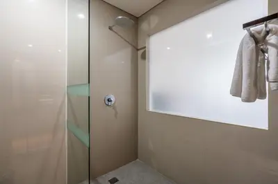 a shower with a glass door in a bathroom at Casa Dasa Legian in Seminyak