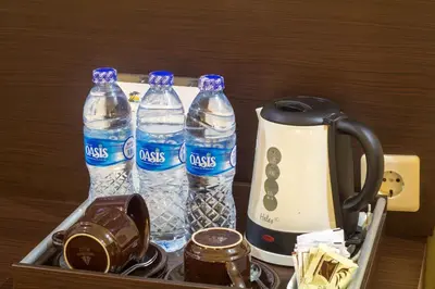 a tray with three bottles of water and a blender at Bali Sandy Resort in Kuta