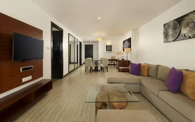 a living room with a couch and a tv at Lv8 Resort Hotel in Canggu